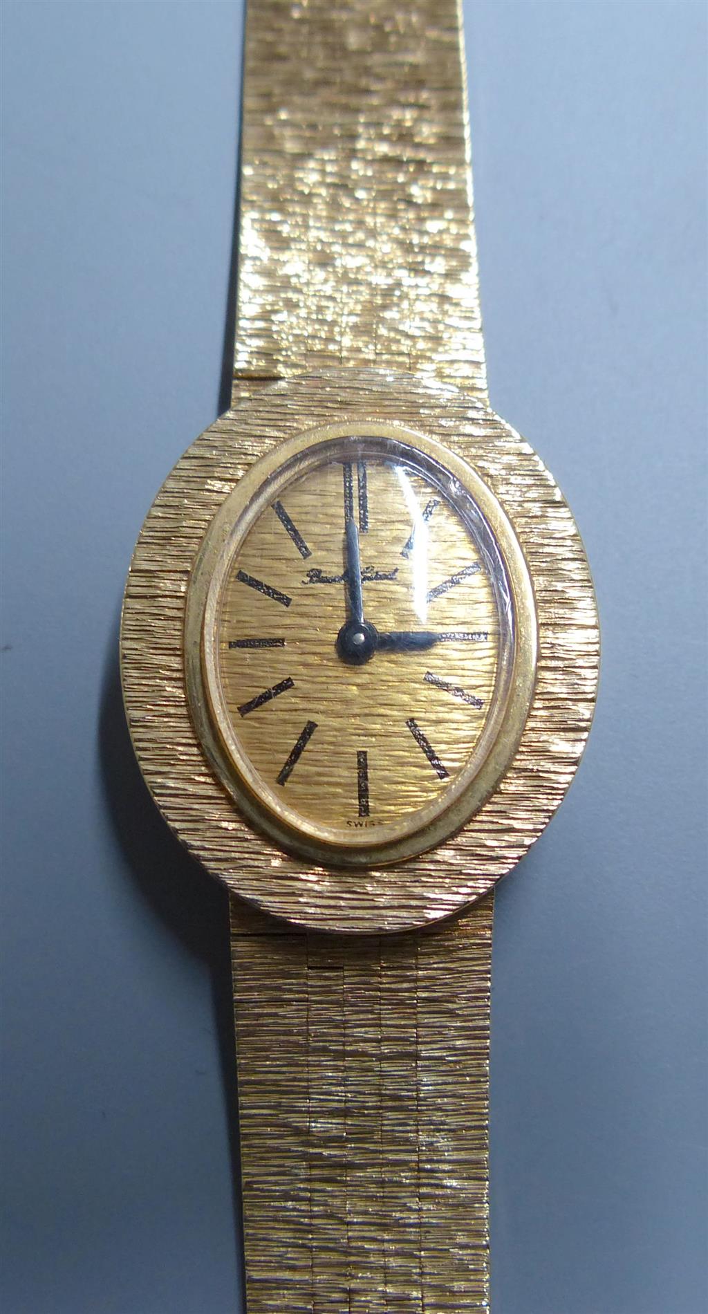 A ladys 9ct gold Bueche Girod manual wind wrist watch, on a textured 9ct gold bracelet, 15.7cm, gross 23.5 grams.